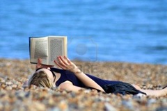 5408049-a-girl-reading-a-book-on-the-beach